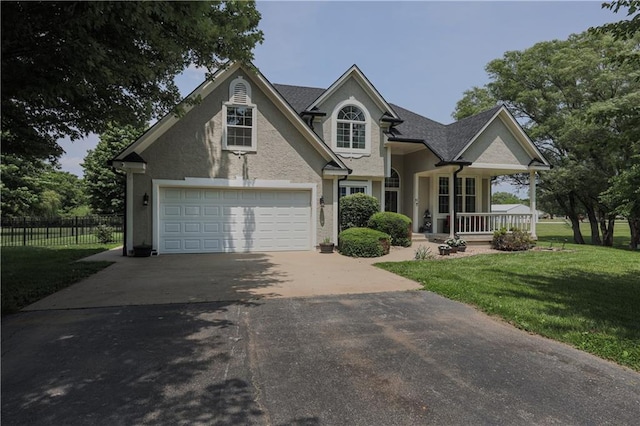 11702 E 246th St, Peculiar, MO 64078 - view of front of property with a porch, asphalt driveway, a garage, and stucco siding