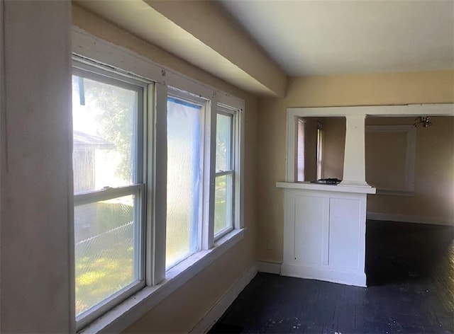 8201 Lydia Ave, Kansas City, MO 64131 - unfurnished dining area with dark wood-type flooring and baseboards