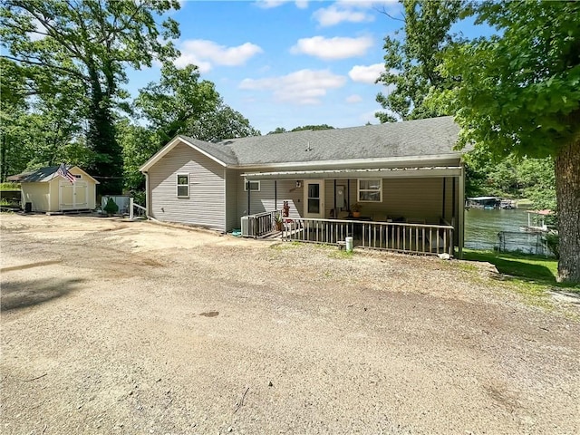 15157 Bass Cove Rd, Gravois Mills, MO 65037 - view of front of home with central AC and a shingled roof