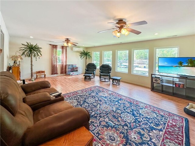 15157 Bass Cove Rd, Gravois Mills, MO 65037 - living area featuring a ceiling fan, a wall mounted air conditioner, wood finished floors, recessed lighting, and baseboards
