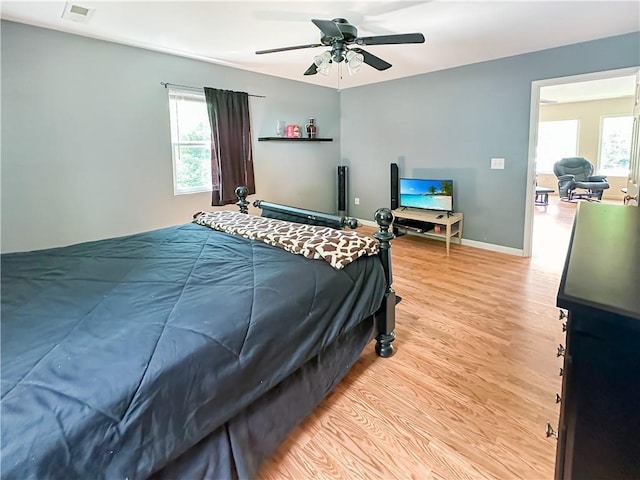 15157 Bass Cove Rd, Gravois Mills, MO 65037 - bedroom with light wood finished floors, baseboards, and a ceiling fan