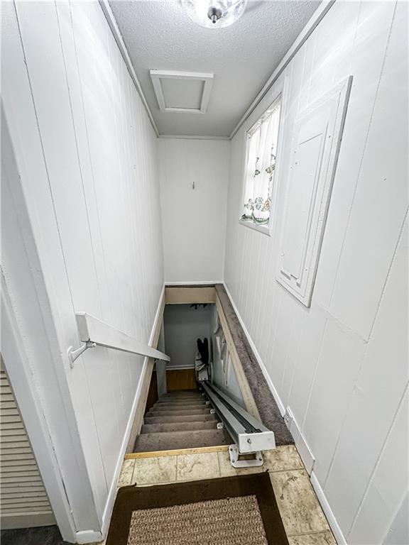 15157 Bass Cove Rd, Gravois Mills, MO 65037 - stairs with a textured ceiling