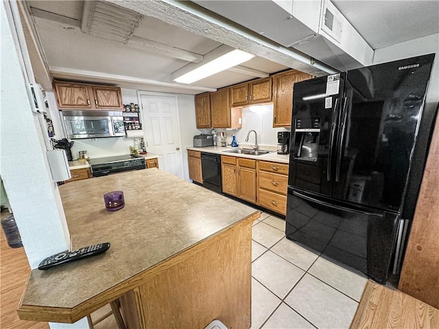 15157 Bass Cove Rd, Gravois Mills, MO 65037 - kitchen with black appliances, a sink, brown cabinets, light tile patterned floors, and light countertops