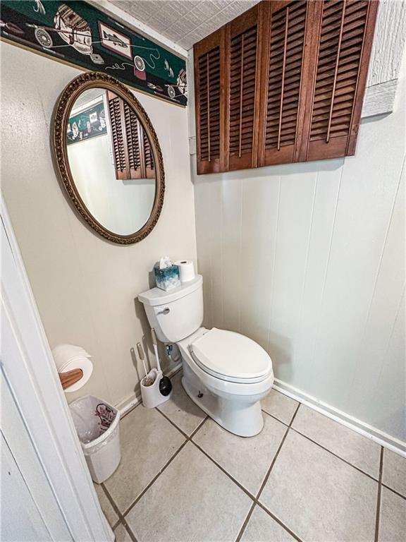 15157 Bass Cove Rd, Gravois Mills, MO 65037 - half bath featuring toilet and tile patterned flooring