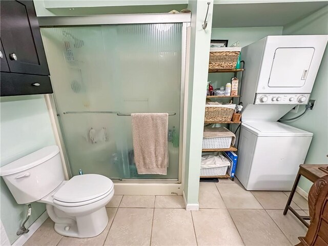 15157 Bass Cove Rd, Gravois Mills, MO 65037 - full bath featuring stacked washing machine and dryer, a shower stall, toilet, tile patterned floors, and baseboards