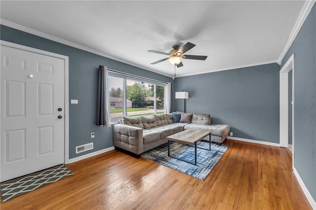 7316 E 109th St, Kansas City, MO 64134 - living area featuring wood finished floors, a ceiling fan, baseboards, and crown molding