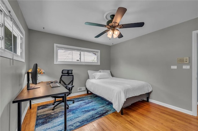 7316 E 109th St, Kansas City, MO 64134 - bedroom with light wood-type flooring, baseboards, an office area, and a ceiling fan
