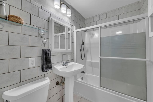 7316 E 109th St, Kansas City, MO 64134 - bathroom featuring toilet, bath / shower combo with glass door, tile walls, and tasteful backsplash