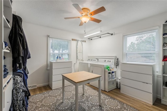 8726 W 104th St, Overland Park, KS 66212 - laundry area featuring independent washer and dryer, wood finished floors, ceiling fan, and a textured ceiling