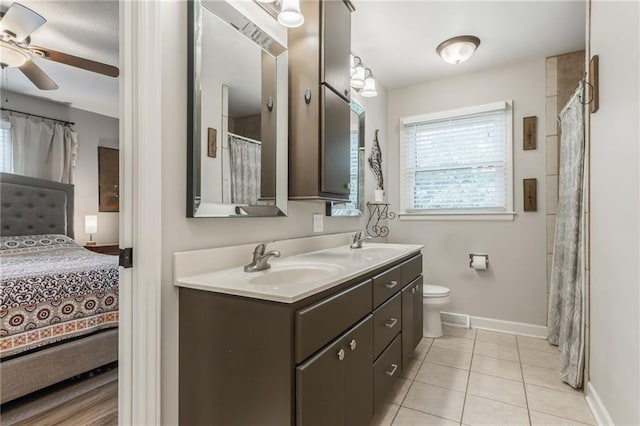 8726 W 104th St, Overland Park, KS 66212 - ensuite bathroom featuring plenty of natural light, double vanity, ceiling fan, and baseboards