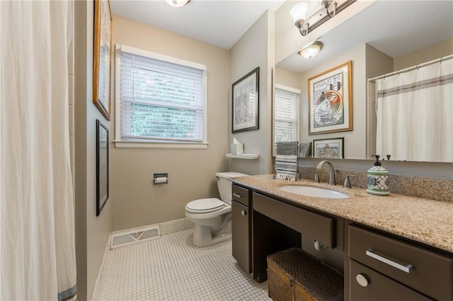8726 W 104th St, Overland Park, KS 66212 - full bath featuring vanity, toilet, baseboards, tile patterned floors, and curtained shower