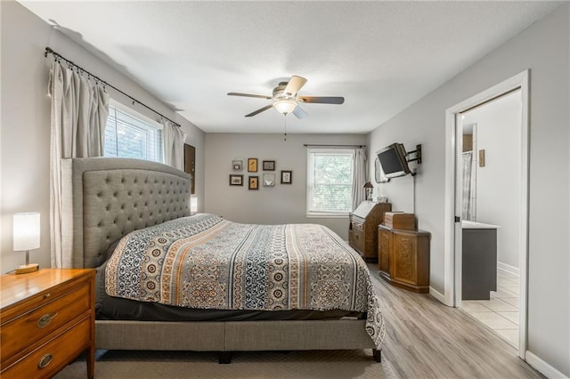 8726 W 104th St, Overland Park, KS 66212 - bedroom with light wood-type flooring, a ceiling fan, and baseboards