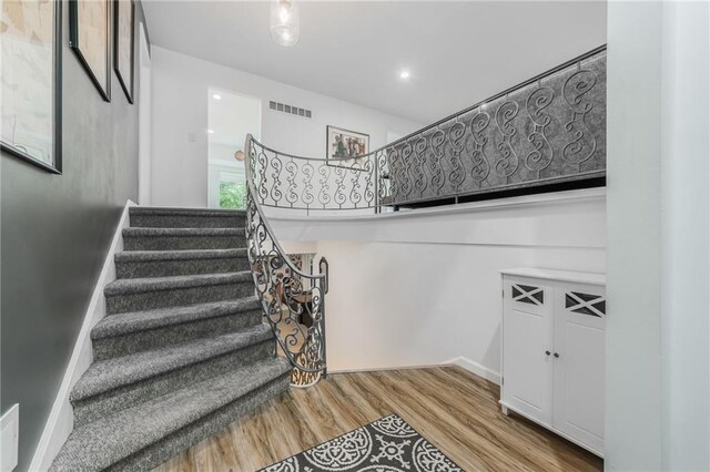 8726 W 104th St, Overland Park, KS 66212 - stairs featuring wood finished floors and baseboards
