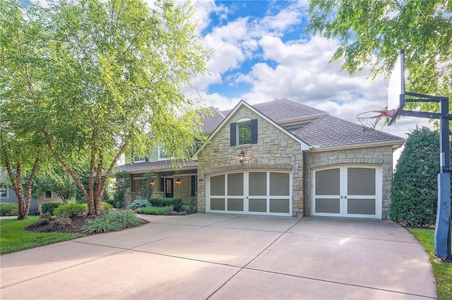 15225 Perry St, Overland Park, KS 66221 - view of front facade featuring stone siding, concrete driveway, a garage, and a shingled roof