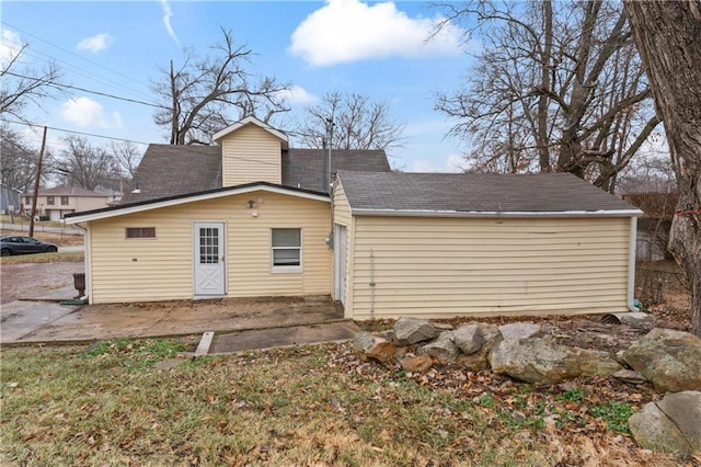 7 NW 88th St, Kansas City, MO 64155 - back of property with a shingled roof and a patio area