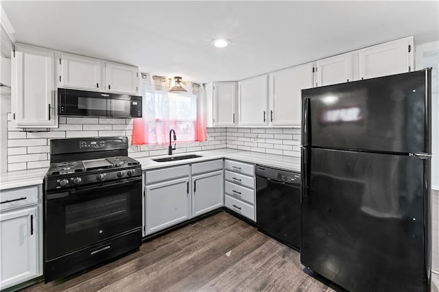 7 NW 88th St, Kansas City, MO 64155 - kitchen featuring black appliances, a sink, light countertops, dark wood-style floors, and white cabinets