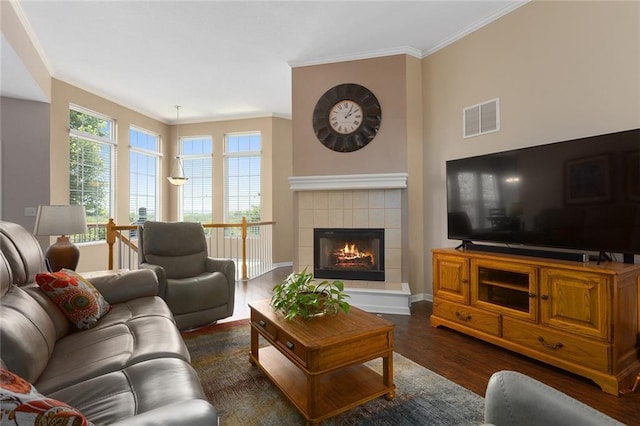8108 NE 113th St, Kansas City, MO 64157 - living area with crown molding, dark wood-style floors, and a tile fireplace
