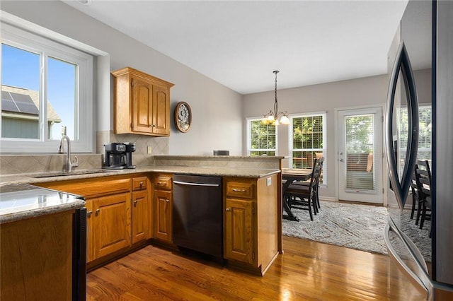 8108 NE 113th St, Kansas City, MO 64157 - kitchen featuring stainless steel appliances, dark wood finished floors, plenty of natural light, and a chandelier