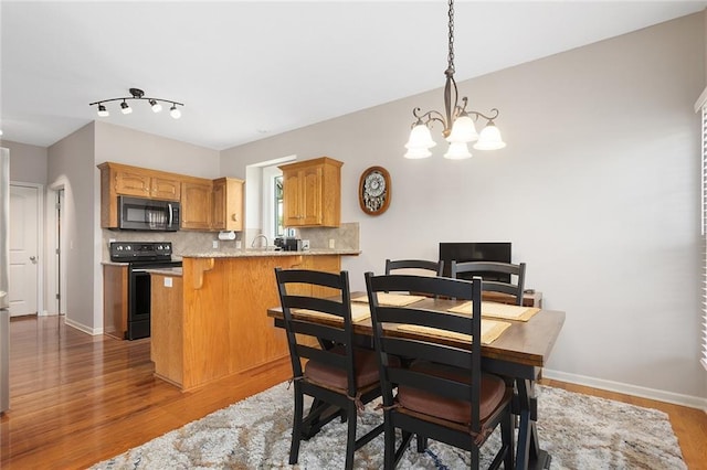 8108 NE 113th St, Kansas City, MO 64157 - dining area featuring wood finished floors and a chandelier