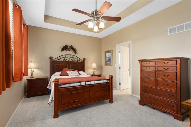 8108 NE 113th St, Kansas City, MO 64157 - bedroom featuring light carpet, a ceiling fan, and a tray ceiling