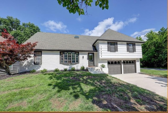 10409 Russell St, Overland Park, KS 66212 - split level home featuring a garage, driveway, brick siding, and a front lawn