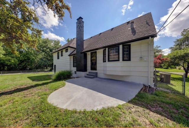 10409 Russell St, Overland Park, KS 66212 - rear view of property featuring a patio, a chimney, roof with shingles, and cooling unit