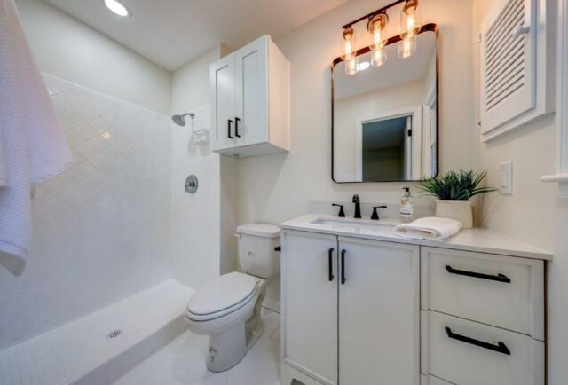 10409 Russell St, Overland Park, KS 66212 - full bathroom with vanity, toilet, and a tile shower