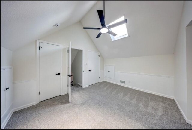 10409 Russell St, Overland Park, KS 66212 - bonus room with carpet floors, lofted ceiling, a ceiling fan, a skylight, and baseboards