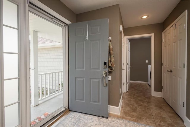 130 SW 95th Rd, Warrensburg, MO 64093 - foyer with baseboards, washer / clothes dryer, light tile patterned flooring, and recessed lighting