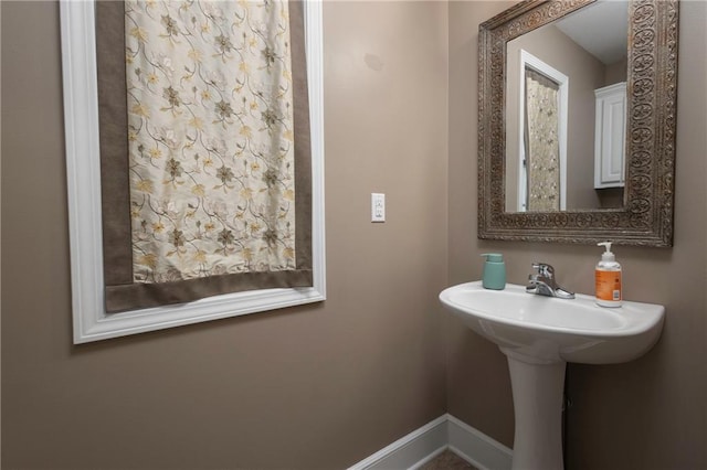 130 SW 95th Rd, Warrensburg, MO 64093 - bathroom featuring baseboards and a sink