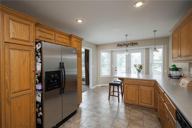 130 SW 95th Rd, Warrensburg, MO 64093 - kitchen with appliances with stainless steel finishes, a peninsula, a kitchen bar, brown cabinetry, and recessed lighting