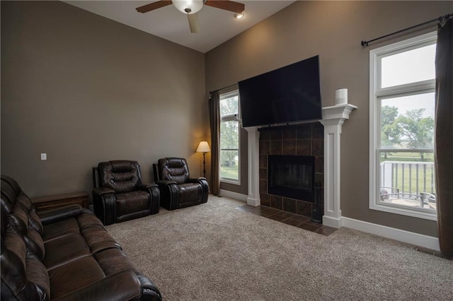 130 SW 95th Rd, Warrensburg, MO 64093 - living room featuring carpet, a ceiling fan, a fireplace, and baseboards