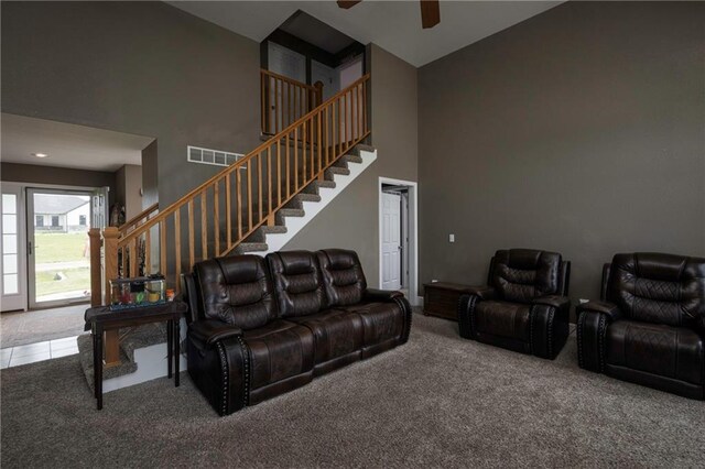 130 SW 95th Rd, Warrensburg, MO 64093 - carpeted living area with a high ceiling, a ceiling fan, and stairs