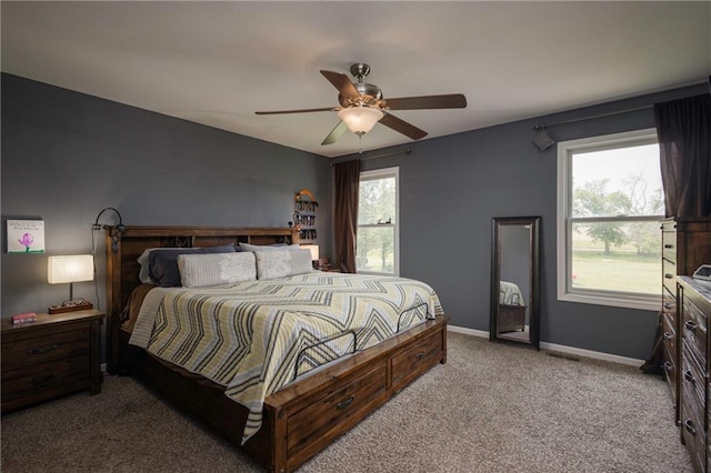 130 SW 95th Rd, Warrensburg, MO 64093 - bedroom with multiple windows, carpet floors, baseboards, and ceiling fan