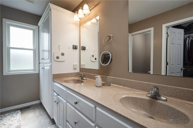 130 SW 95th Rd, Warrensburg, MO 64093 - bathroom with double vanity, tile patterned flooring, and baseboards