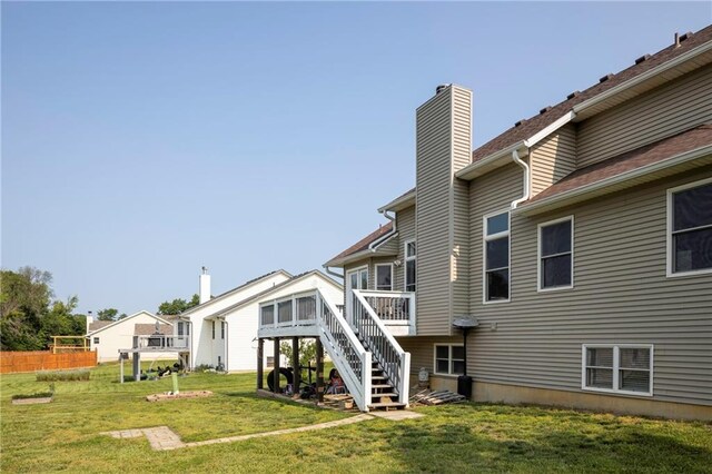 130 SW 95th Rd, Warrensburg, MO 64093 - rear view of house with a chimney, stairs, a lawn, and a deck