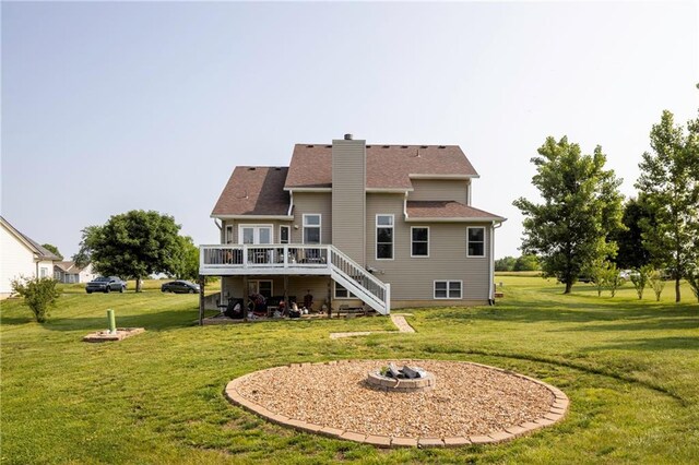 130 SW 95th Rd, Warrensburg, MO 64093 - back of house with a fire pit, a wooden deck, stairway, and a lawn