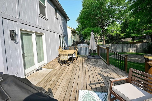 17586 W 112th St, Olathe, KS 66061 - wooden terrace with outdoor dining area and a fenced backyard