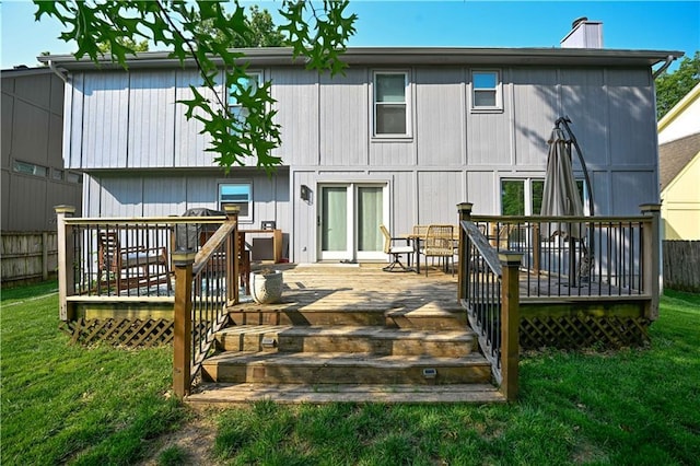 17586 W 112th St, Olathe, KS 66061 - back of property with a lawn, a chimney, a deck, and outdoor dining space