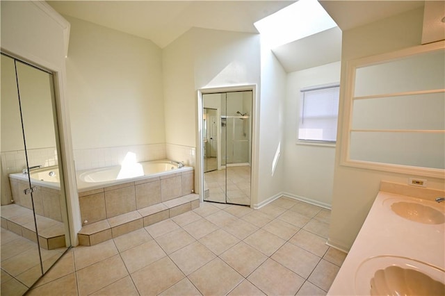 17586 W 112th St, Olathe, KS 66061 - full bath with a garden tub, tile patterned flooring, vaulted ceiling, double vanity, and baseboards
