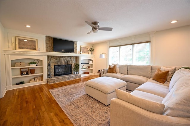 17586 W 112th St, Olathe, KS 66061 - living area featuring ceiling fan, a stone fireplace, recessed lighting, wood finished floors, and built in shelves