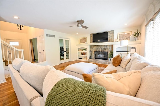 17586 W 112th St, Olathe, KS 66061 - living room featuring ceiling fan, wood finished floors, a stone fireplace, baseboards, and recessed lighting