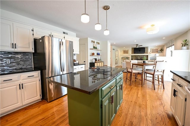 17586 W 112th St, Olathe, KS 66061 - kitchen with freestanding refrigerator, green cabinetry, white cabinetry, backsplash, and a center island