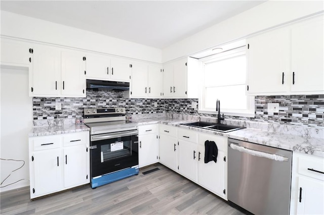 956 Ridge Dr, Warrensburg, MO 64093 - kitchen with stainless steel appliances, a sink, under cabinet range hood, and white cabinetry