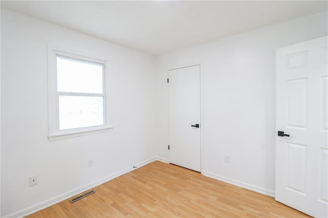 956 Ridge Dr, Warrensburg, MO 64093 - unfurnished bedroom featuring light wood finished floors and baseboards