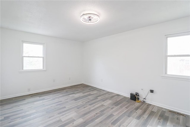 956 Ridge Dr, Warrensburg, MO 64093 - spare room with wood finished floors and baseboards