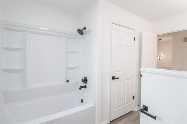 956 Ridge Dr, Warrensburg, MO 64093 - full bathroom featuring wood finished floors and tub / shower combination