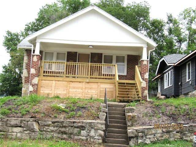 2119 N 32nd St Unit K, Kansas City, KS 66104 - view of front of house featuring stairway, brick siding, and a porch