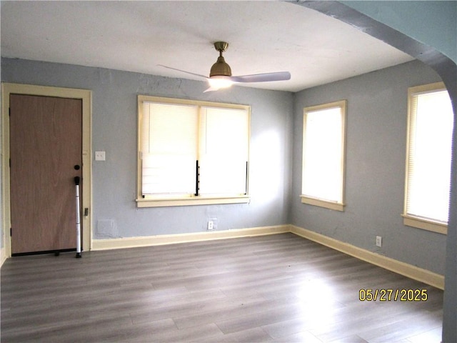2119 N 32nd St Unit K, Kansas City, KS 66104 - spare room featuring wood finished floors, a ceiling fan, baseboards, and arched walkways