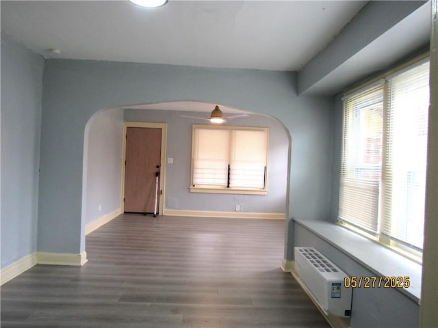 2119 N 32nd St Unit K, Kansas City, KS 66104 - empty room featuring arched walkways, wood finished floors, baseboards, and a ceiling fan